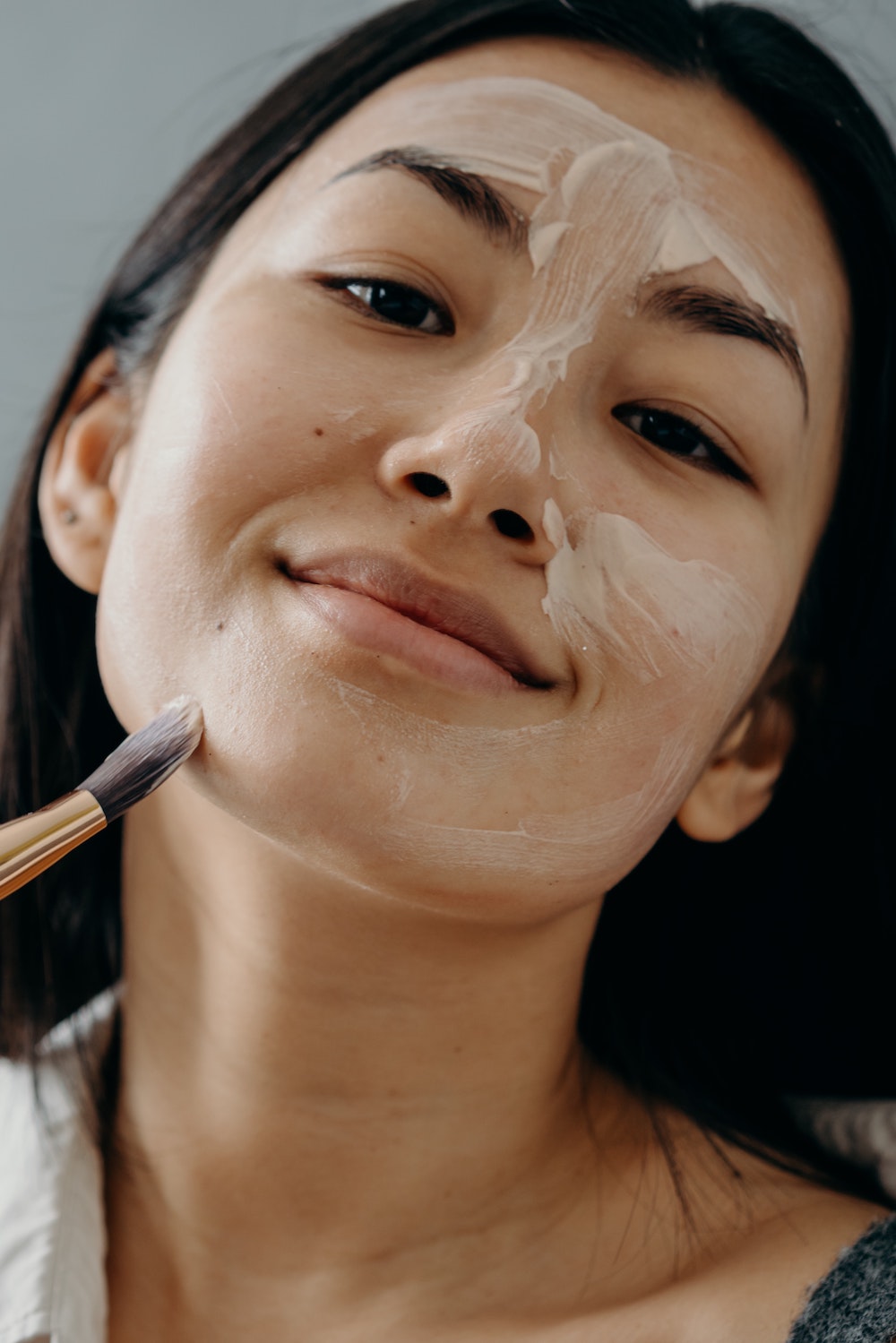 woman putting on a face mask